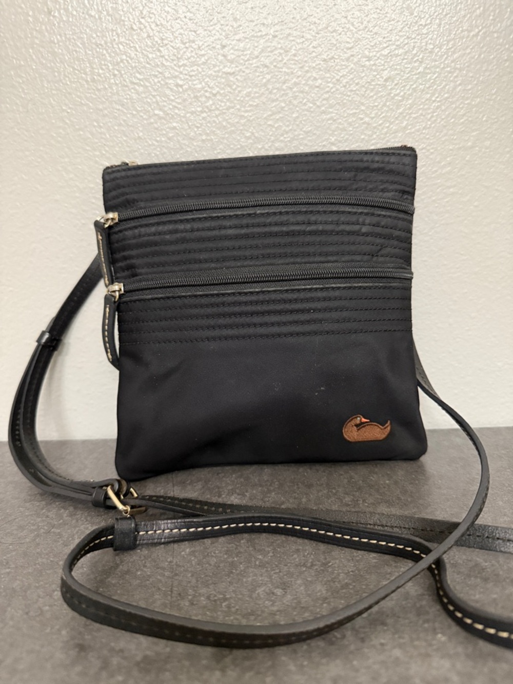 Dooney & Bourke Black Crossbody with brown Logo Patch